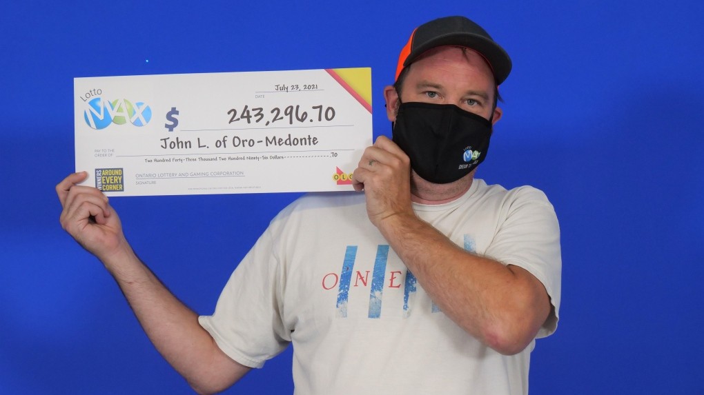 John Lloyd of Oro-Medonte, Ontario, holds his cheque for $243,296.70 after winning second prize in the July 16, 2021 Lotto Max draw. (OLG)