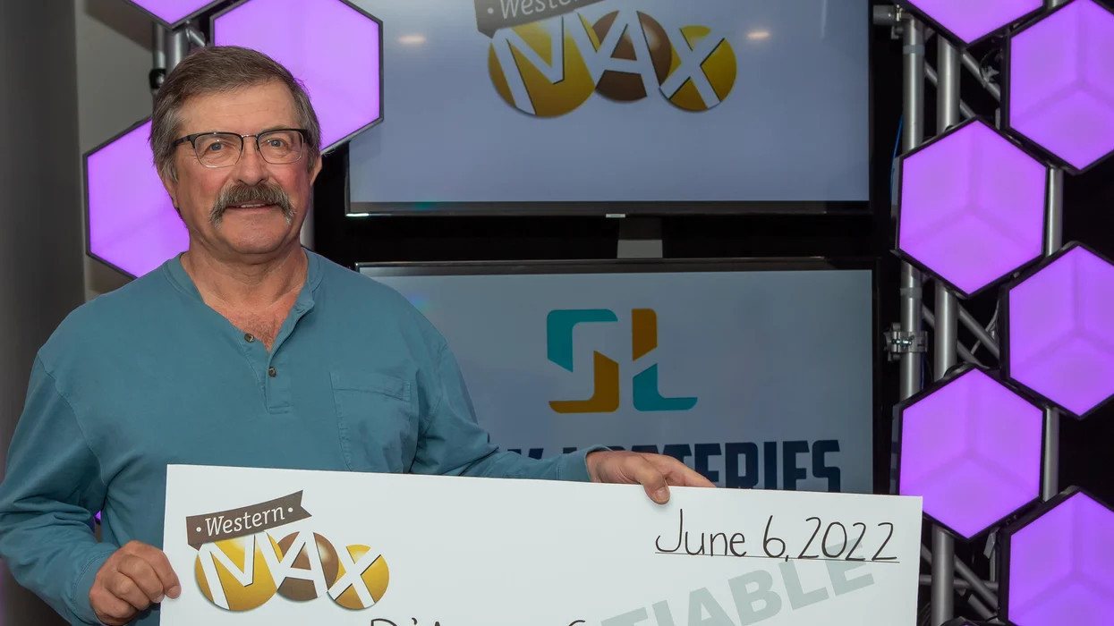 Lucky D'Arcy Glover with his Western Max Lottery draw winner's cheque.